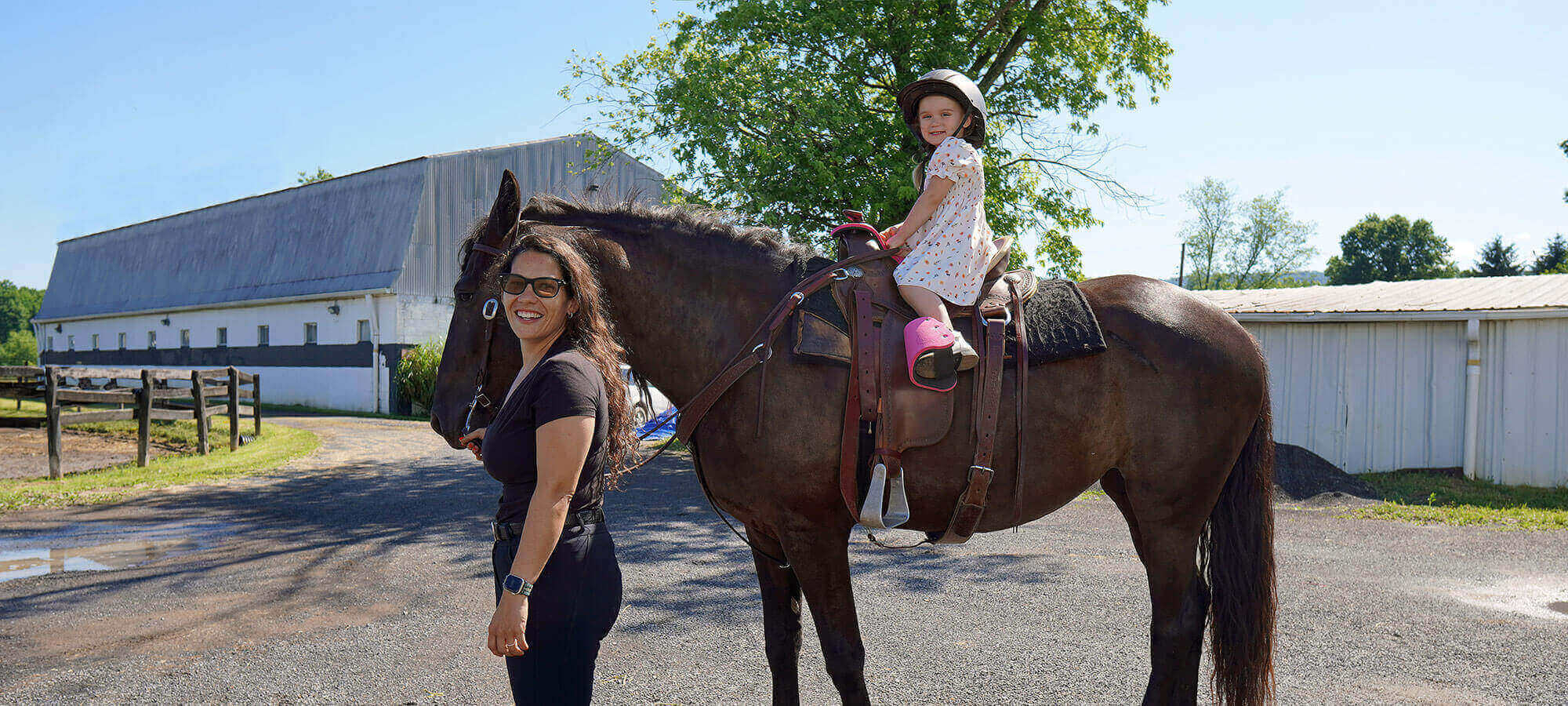 Woman By Girl Riding Horse